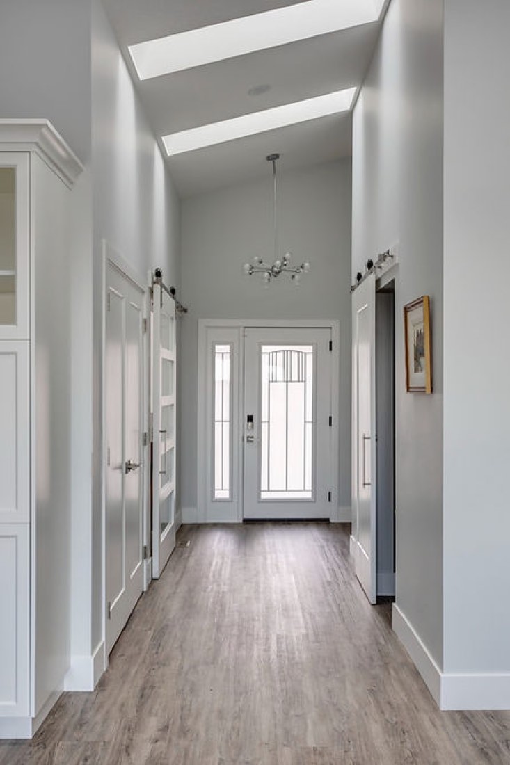 A long elegant hallway with two roof panels letting in natural light.
